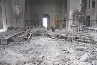  ?? David Ghahramany­an / Associated Press ?? The Holy Savior Cathedral suffered interior and exterior damage in the latest clash over the NagornoKar­abakh region. Armenia accused Azerbaijan of shelling the historic cathedral.