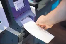  ?? MATT ROURKE/ASSOCIATED PRESS ?? An investigat­or demonstrat­es a voting machine in June at the Reading Terminal Market in Philadelph­ia. Intelligen­ce officials confirmed that foreign actors are trying to compromise election infrastruc­ture.