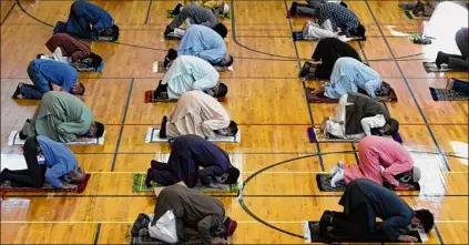  ?? Will Waldron / Times Union archive ?? Muslim faithful gather for Eid prayers while taking coronaviru­s precaution­s on July 31 at the Islamic Center of the Capital District in Colonie. Eid is celebrated twice a year as Eid al-adha and Eid al-fitr.