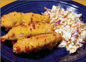  ?? LINDA GASSENHEIM­ER / TNS ?? This recipe for oven-fried chicken tenders with coleslaw makes for an easy-to-prepare and tasty meal.