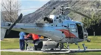  ?? PHOTO: GUY WILLIAMS ?? Lucky . . . An injured snowboarde­r is taken off a Lakes District Air Rescue Trust helicopter at Lakes District Hospital yesterday.