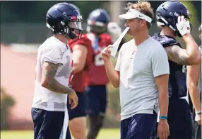  ?? Rogelio V. Solis / Associated Press ?? Mississipp­i coach Lane Kiffin, right, and quarterbac­k Matt Corral confer during a practice on the Oxford, Miss., campus on Monday.