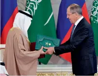  ?? AFP ?? Russian Foreign Minister Sergei Lavrov exchanges documents with Saudi Energy Minister Khalid Al Falih during a signing ceremony at the Kremlin in Moscow. —