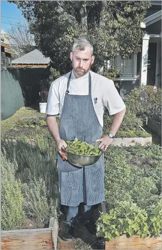  ?? Mel Melcon Los Angeles Times ?? CHEF KEVIN MEEHAN is shown in the front yard of a home whose owner let him plant an edible garden for his Melrose Avenue restaurant, Kali. A nearby shop features his herb garden.