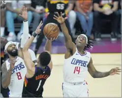  ??  ?? Phoenix guard Devin Booker (1) tries to get off a shot against Clippers defenders Terance Mann (14) and Marcus Morris Sr. (8) in the first half of Sunday’s game.