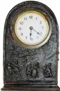  ??  ?? A novelty clock from about 1900 in stamped sheet brass with an oxidized copper finish may have been made with young people in mind.