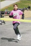  ?? KEVIN TUSTIN – DIGITAL FIRST MEDIA ?? Drexel Hill’s Armani Moyer, 12, wins the kids run before going on to the 5K.