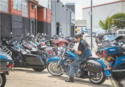  ?? Drew Angerer, Getty Images North America ?? A man picks up his Harley-Davidson motorcycle from the service garage of the Harley-Davidson of New York City showroom in the Queens borough on Monday.
