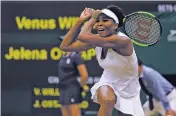  ?? ALASTAIR GRANT/THE ASSOCIATED PRESS ?? Venus Williams returns to Latvia’s Jelena Ostapenko during their women’s quarterfin­al singles match Tuesday at Wimbledon.