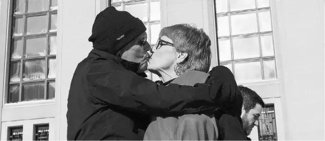  ?? Sean Kilpat
rick / The Associat ed Press ?? Lee Carter, right, and her husband, Hollis Johnson, kiss outside The Supreme Court of Canada on Friday morning in Ottawa. Canada’s highest court unanimousl­y struck down a ban on doctor-assisted suicide for mentally competent patients with terminal...