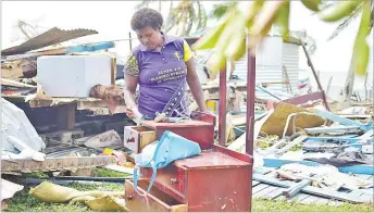  ?? Picture: FT FILE ?? 12 homes were damaged by TC Yasa on Galoa Island. Maraia Volau is seen here
looking for what is left of her home in Galoa.