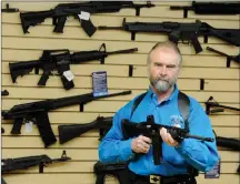  ?? ?? A gun shop owner in California with an AR-15-style rifle