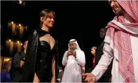  ?? Photograph: Patrick Baz/Red Sea Film Festival/AFP/Getty
Images ?? The chairman Mohammed al-Turki welcoming Hillary Swank at the opening of the first edition of the festival in Jeddah.