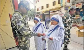  ?? REUTERS ?? Security personnel check the voter ID of nuns in Kolkata during the third phase of polls on Thursday. Throughout the day sporadic clashes were reported and 960 complaints lodged.