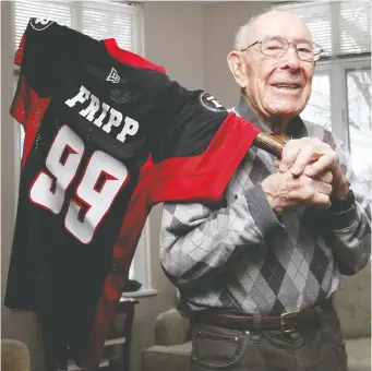  ?? TONY CALDWELL FILES ?? For his birthday last year, friends presented John Fripp with a Redblacks jersey emblazoned with his name and the number 99, in honour of his age at the time, on the back. Fripp is the oldest living alumni of both the Ottawa Rough Riders and the CFL, and today will receive a special video message from league commission­er Randy Ambrosie.