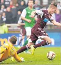  ?? Picture: SNS Group. ?? Billy King skips round Hibs keeper Ben Williams to score Hearts second goal.