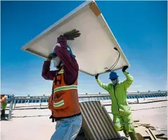  ??  ?? Sun-kissed area: Workers installing solar panels in the desert near Villanueva, a town located in the municipali­ty of Viesca, Coahuila State, Mexico.
— AFP