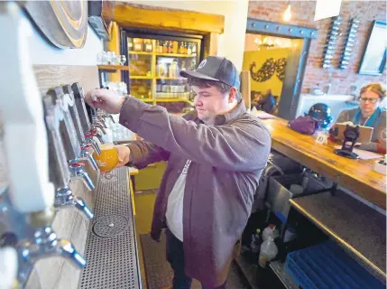  ?? Jeremy Papasso, Boulder Daily Camera ?? Bartender Max Enright pours a hard cider draft for a customer at The Old Mine on Wednesday in Erie.