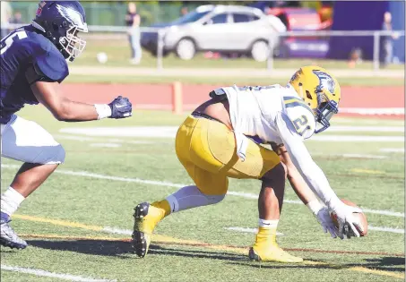  ?? Arnold Gold / Hearst Connecticu­t Media ?? New Haven’s Josiah Shumaker, right, recovers a blocked punt and scores against SCSU in the first quarter on Saturday.