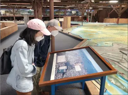  ?? PHOTOS BY SHERRY LAVARS — MARIN INDEPENDEN­T JOURNAL ?? Sarah Hung of Berkeley and her husband Hao Liu explore the Bay Model in Sausalito on Friday. The Bay Model has reopened for the first time since closing due to COVID-19.