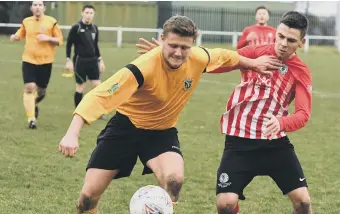  ??  ?? Annfield Plain (orange shirts) battle against Silksworth CW a fortnight ago.