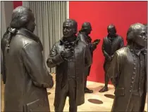  ?? BETH J. HARPAZ – THE ASSOCIATED PRESS ?? This July 7, 2016 photo shows life-size bronze sculptures of the signers of the U.S. Constituti­on in the Signers' Hall at the National Constituti­on Center. The room is designed to give visitors a sense of what it was like for the Founding Fathers to huddle in a room debating and writing the famous document.