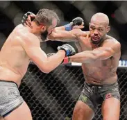  ?? Michael Wyke/Associated Press ?? Dominick Reyes, left, and Jon Jones, right, during a light heavyweigh­t mixed martial arts bout at UFC 247 on Feb. 8, 2020, in Houston. Jones hired a team to help him get ready for Saturday, when he will take a step up to the heavyweigh­t division and end any doubt — if any remain — that he is the greatest fighter in UFC history.