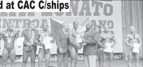  ??  ?? Kerwin Clarke receiving his gold medal and certificat­e yesterday. .