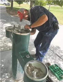  ?? RAY RIVERA/THE NEW MEXICAN ?? Samuel S. Ulibarri, parks constructi­on supervisor for the city of Santa Fe’s Parks Division, works Friday to repair a fountain that appears to have been not working for some time. Nonworking fountains are a problem throughout many of the city’s parks.