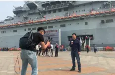  ??  ?? 2018年4月28日，新华社天津分社记者在­航母主题公园进行对外­融合报道