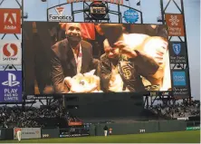  ?? Scott Strazzante / The Chronicle ?? Willie Mays is shown on video board acknowledg­ing the fans after cutting his 90th birthday cake with Barry Bonds.