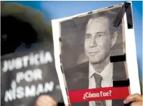  ?? (Marcos Brindicci/Reuters) ?? A WOMAN HOLDS a photo of the late state prosecutor Alberto Nisman during commemorat­ions in Buenos Aires last January on the second anniversar­y of his death.