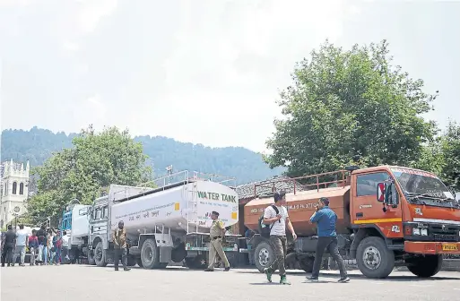  ?? AFP PHOTOS/GETTY IMAGES ?? Tankers queue as Shimla faces a water shortage. City officials have cancelled a popular June festival and hotels are asking incoming guests to put off holiday plans.