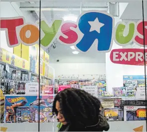  ?? CHRISTOPHE­R LEE BLOOMBERG ?? A pedestrian passes in front of a Toys “R” Us Express store in New York.
