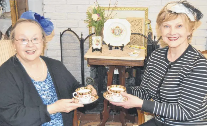  ?? SALLY COLE THE GUARDIAN ?? In Charlottet­own, Penelope Player, left, and Rowena Hickox prepare to lift their teacups in honour of the royal wedding of Prince Harry and Meghan Markle. The royal wedding took place Saturday at St. George’s Chapel at Windsor Chapel in Britain.