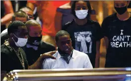  ?? GODOFREDO A. VÁSQUEZ — HOUSTON CHRONICLE VIA AP, POOL ?? Houston rapper Cal Wayne looks at the casket of his friend, George Floyd, during a public visitation Monday at The Fountain of Praise church in Houston.