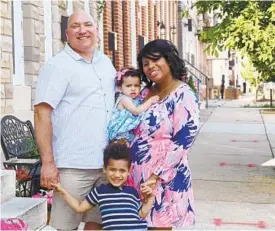  ?? KIM HAIRSTON/BALTIMORE SUN ?? Bill and Shanna Janu, with Wesley and Cordelia, near their Federal Hill home in June. They’re raising a family in a city and country full of dangers for young Black people.