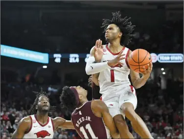  ?? Associated Press ?? Fouled: Arkansas guard Ricky Council IV (1) is fouled by Mississipp­i State guard Eric Reed Jr. (11) as he drives to the hoop during an NCAA college basketball game Saturday in Fayettevil­le.