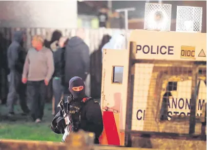  ?? PHOTO: NIALL CARSON/PA WIRE ?? Violence: Armed police in Creggan, Derry, where journalist Lyra McKee was shot dead on Thursday night.
