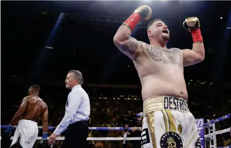  ??  ?? ANDY RUIZ, right, celebrates after the third round of a heavyweigh­t championsh­ip boxing match against Anthony Joshua, left, Saturday, June 1, 2019, in New York. Ruiz won in the seventh round. (AP)