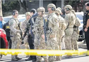  ?? REUTERS ?? San Mateo County Swat team officers are seen near YouTube headquarte­rs following an active shooter situation in San Bruno, California.