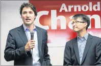  ?? THE CANADIAN PRESS ?? Federal Liberal Leader Justin Trudeau speaks to supporters as he visits Liberal candidate for Scarboroug­h-Agincourt Arnold Chan, right, at his campaign office in Toronto in 2014. Chan has died of cancer.