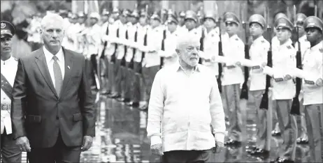  ?? REUTERS/Alexandre Meneghini ?? Cuba's President Miguel Diaz-Canel (left) and Brazil's President Luiz Inacio Lula da Silva review an honour guard at the Revolution Palace during the G77+China summit in Havana, Cuba, September 16, 2023.