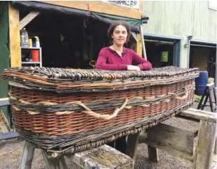  ??  ?? Massachuse­tts: In this photo, Mary Lauren Fraser stands beside a casket she hand-wove from willow, in Montague, Massachuse­tts.—AP