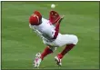  ?? MATT SLOCUM - THE ASSOCIATED PRESS ?? Several outstandin­g defensive plays, like this catch by shortstop Didi Gregorius in the ninth inning, carried the Phillies to a 3-2, 10-inning victory over the Atlanta Thursday in the season opener.