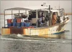  ?? Brian A. Pounds / Hearst Connecticu­t Media ?? Oystermen dredge the bottom of the Housatonic River for seed oysters in Stratford on Feb. 15, 2018.