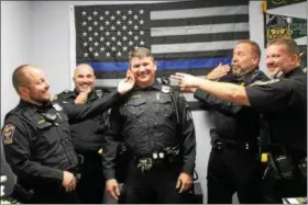  ?? KRISTI GARABRANDT — THE NEWS-HERALD ?? Eastlake police officers Rick Isabella and Gary Hotchkiss, along with Willowick police officers Sgt. Dan Hirz and Steve Fellinger have fun pointing out the lack of facial hair on Eastlake Sgt. Chris Gutka’s face while they show off the facial hair they...