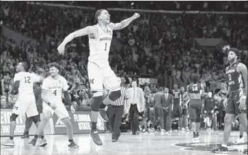  ?? Wally Skalij Los Angeles Times ?? CHARLES MATTHEWS rejoices after coming up clutch in Michigan’s 58-54 win in the West Regional final.