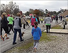  ?? COURTESY PHOTO ?? The annual Turkey Trot is a family affair, with furry friends tagging along for the trot as well. Enjoy colorful fall foliage while travelling the 3.1-mile loop through Southwest City.