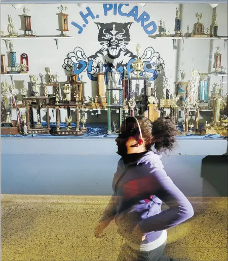  ?? Photos Ed Kaiser, the journal ?? A student walks past the trophy case at J.H. Picard school, which got a new lease on life after Catholic board
trustees rejected Monday an unpopular proposal to close the school on the city’s south side.